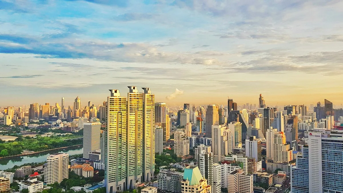 High-rise apartment towers spread across Bangkok in early morning light