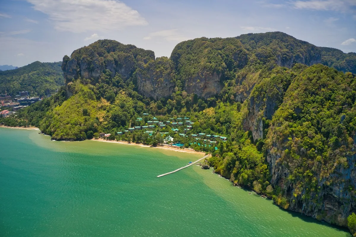 Aerial view of a jungle-backed beach and limestone cliffs on the coast near Ao Nang, Krabi