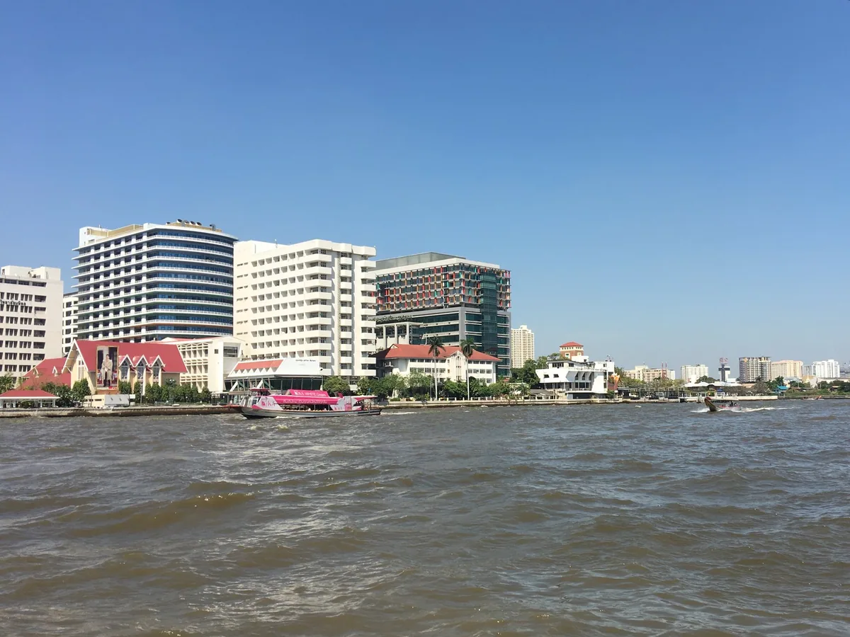 The buildings of Siriraj Hospital on the Chao Phraya riverbank in Bangkok, seen from a cross-river ferry
