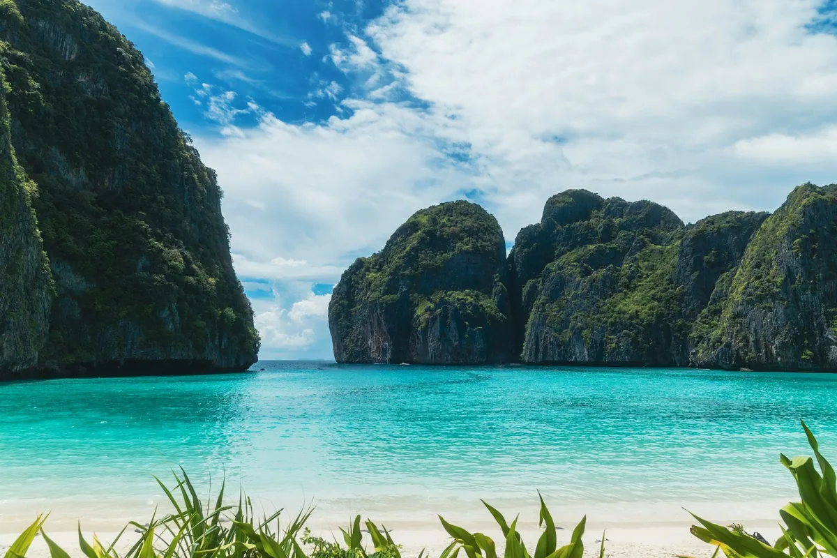 Turquoise water and white sand at Maya Bay, enclosed by tall limestone cliffs on Ko Phi Phi Le