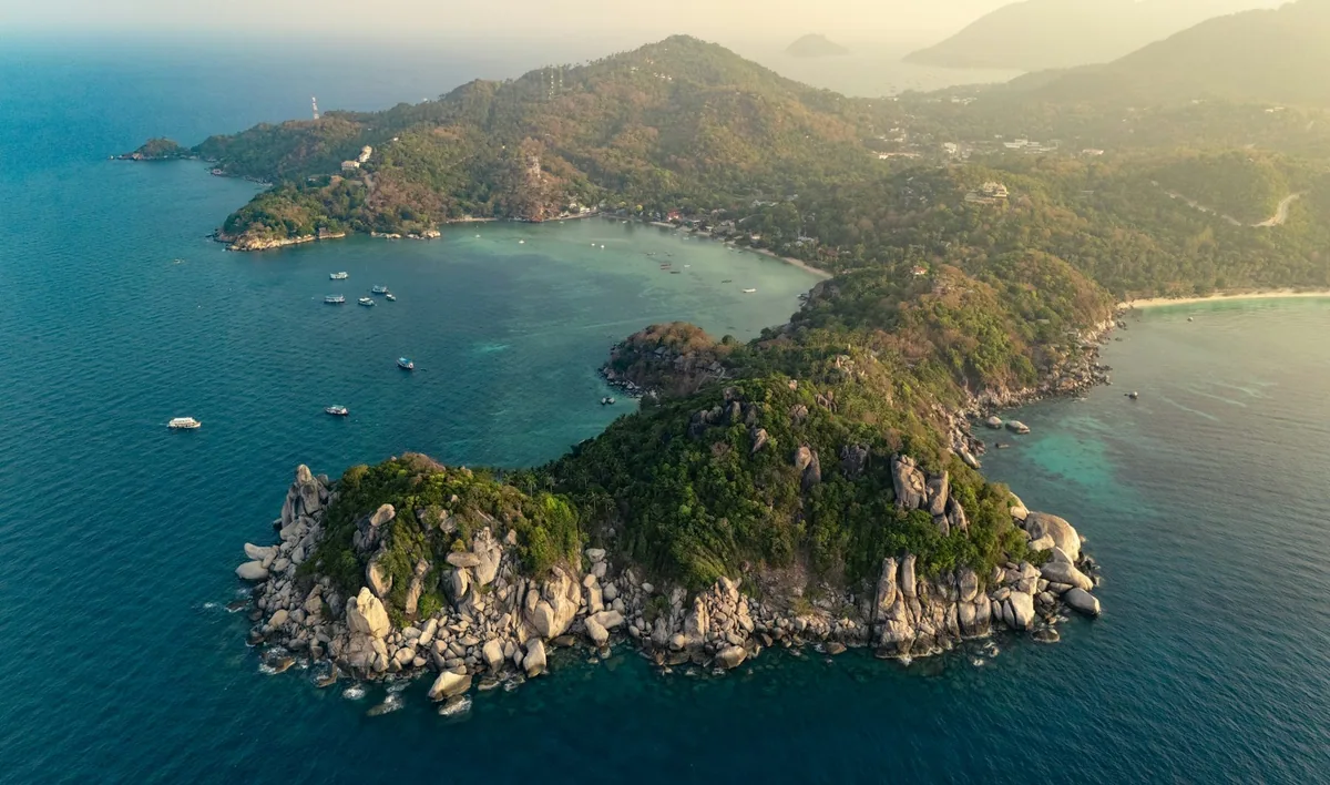 Aerial view of Koh Tao's rocky southern headlands and sheltered bays in soft evening light