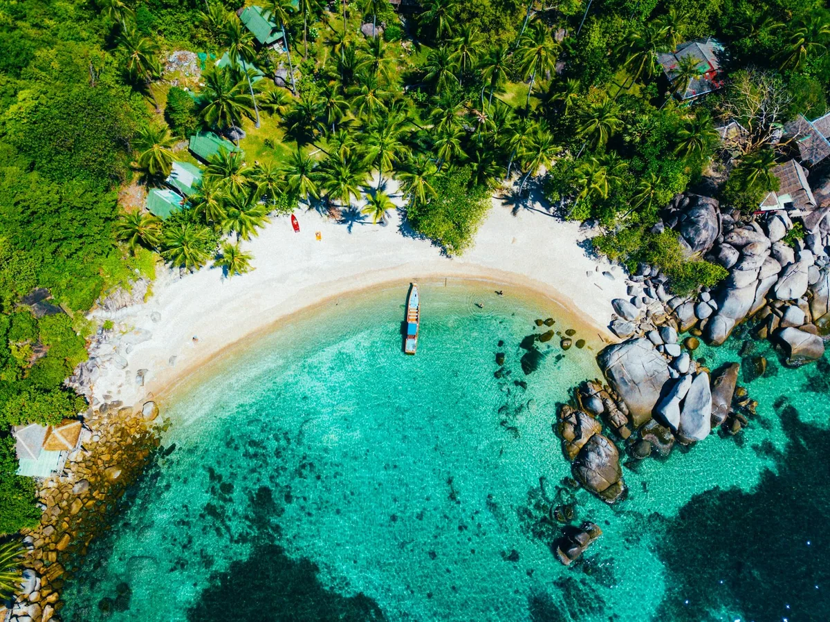 Aerial view of the white sand and granite boulders of Sai Nuan Beach on Koh Tao