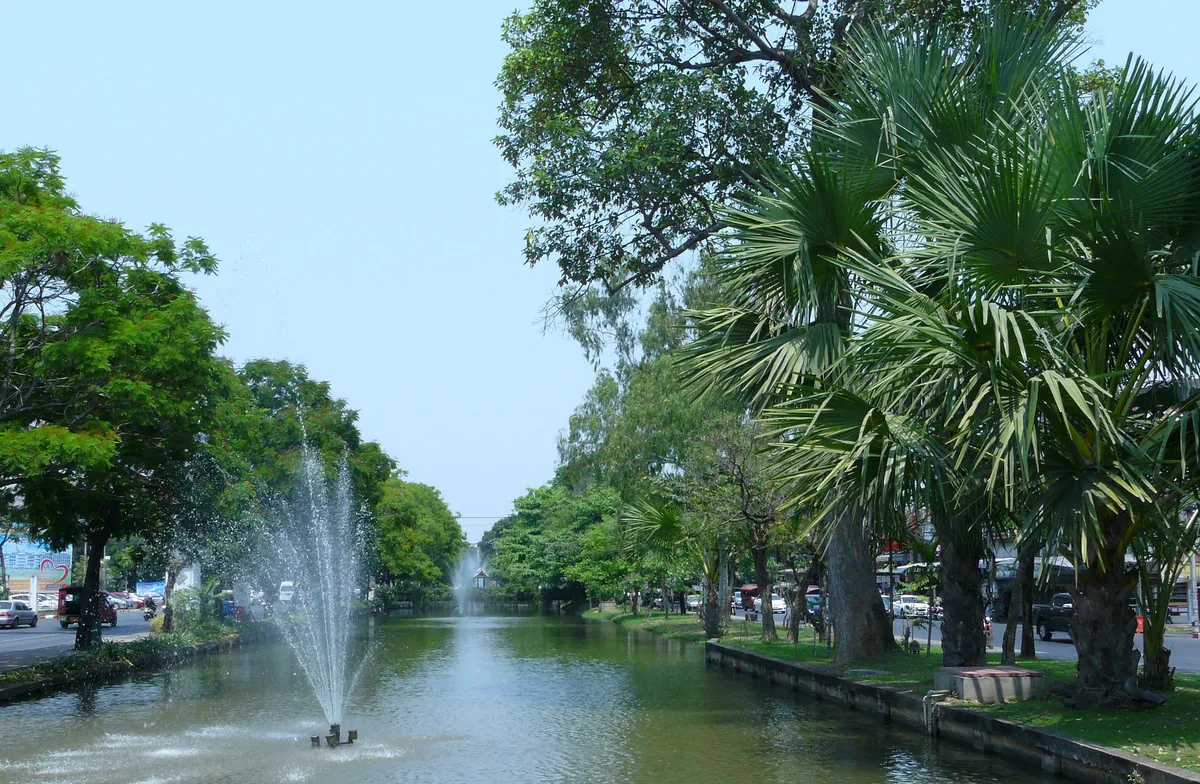 Fountain in Chiang Mai's tree-lined city moat between Suan Dok Gate and Hua Rin Corner