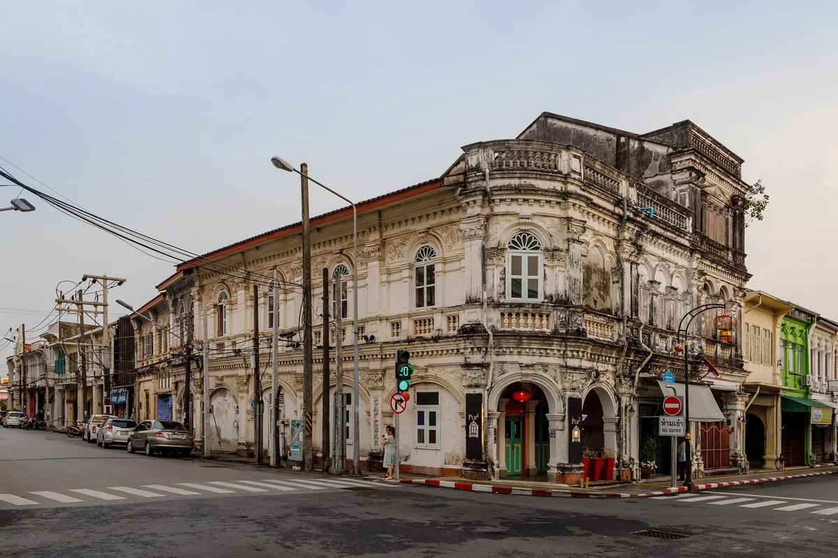 Weathered Sino-Portuguese corner building at the junction of Dibuk Road and Yaowarat Road in Phuket Town