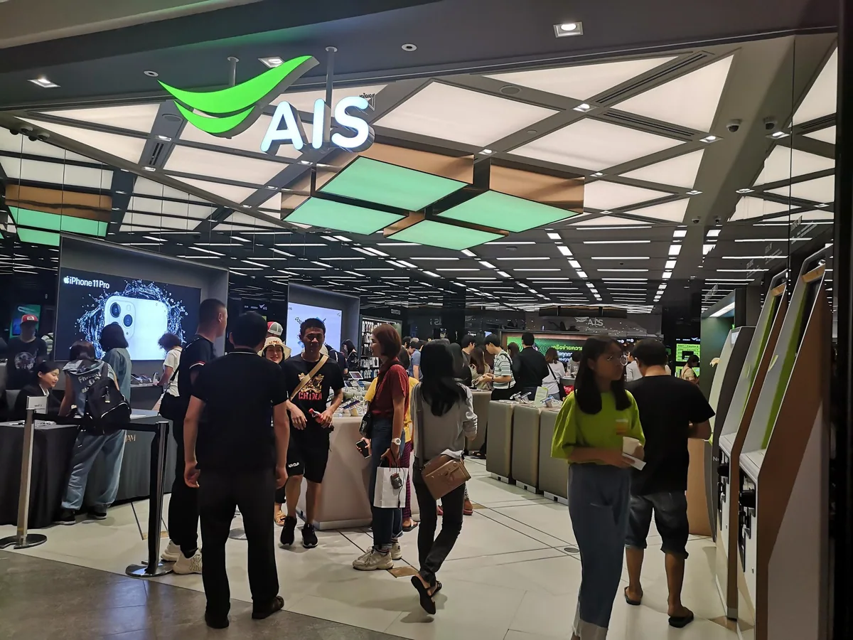 Customers at the counters of an AIS mobile phone shop inside Icon Siam, Bangkok