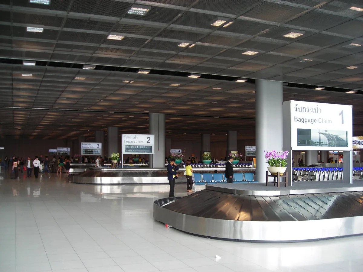 Empty baggage carousels and Baggage Claim signs in the domestic arrivals hall at Suvarnabhumi Airport
