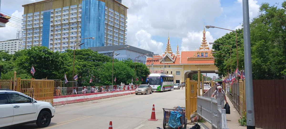 The road across the Aranyaprathet border bridge with the Cambodian gateway arch at Poipet beyond