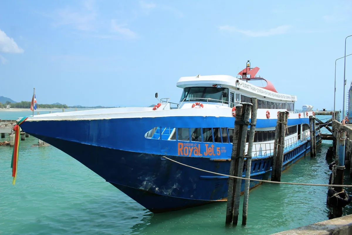 Blue Songserm express boat Royal Jet 5, which links Chumphon with Koh Tao, Koh Phangan and Koh Samui, moored at Nathon Pier