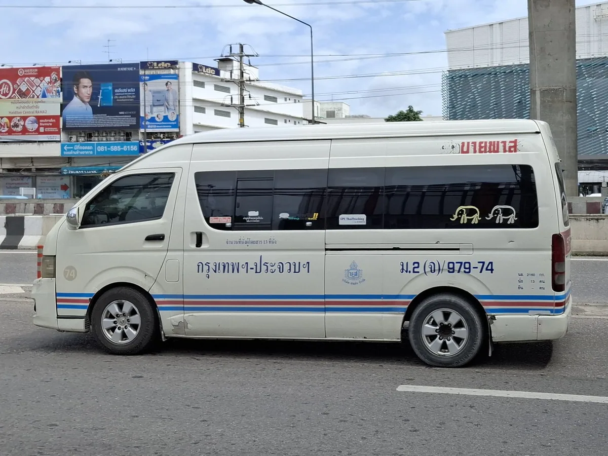 White Toyota Commuter passenger minivan with route markings parked in Bangkok